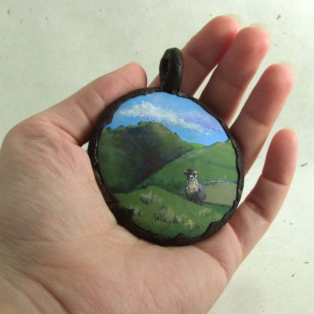 large pendant featuring a sheep painting